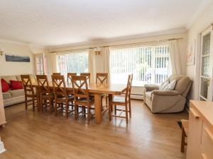 a kitchen and dining room with a table and chairs at Llys Offa in Wynnstay