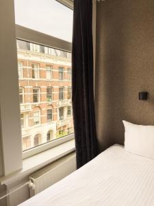 Cama o camas de una habitación en Hotel Vondel Garden - Digital Access