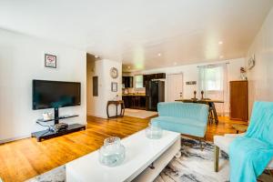 a living room with a couch and a tv at Atlanta Vacation Rental Less Than 10 Mi to Downtown! in Atlanta