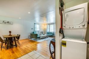 a living room with a refrigerator and a table at Atlanta Vacation Rental Less Than 10 Mi to Downtown! in Atlanta