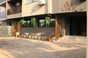 a restaurant with tables and chairs outside of a building at TheLine in Bucharest