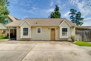 a small yellow house with a driveway at Cozy Shenandoah Home Less Than 2 Mi to The Woodlands Mall! in The Woodlands