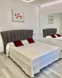 a bedroom with a large bed with red pillows on it at La Dolse Ca' - Lago di Garda in Brenzone sul Garda