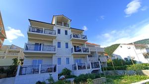a large white building with balconies on it at The Father's House in Bol