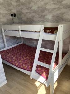 two bunk beds in a room with a ladder at Svanen B&B in Karlsborg