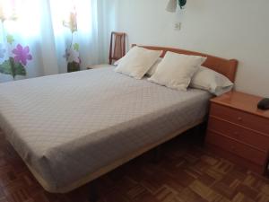 A bed or beds in a room at Hostal Cuzco