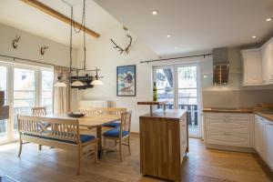 a kitchen and dining room with a table and chairs at Haus Wasmer by AlpenTravel in Bad Hofgastein