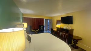 a hotel room with a bed and a flat screen tv at American inn in Elko