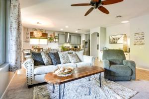 a living room with a couch and a table at Sunny V Arizona Retreat with Private Pool and Patio in Surprise
