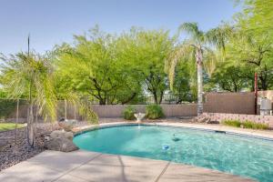 a swimming pool in a yard with trees at Sunny V Arizona Retreat with Private Pool and Patio in Surprise
