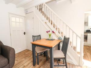 a dining room with a table and chairs at Sandy Shell Cottage in Conwy +7 photos