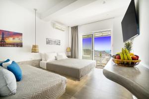 pokój hotelowy z 2 łóżkami i miską owoców w obiekcie Anius Apartments w mieście Mykonos