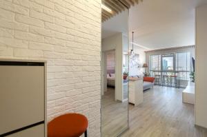 a living room and dining room with a brick wall at 16154 Cozy apartment nearby with Central Railway Station in Kyiv