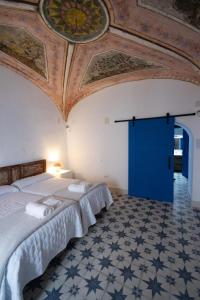 um quarto com uma cama grande e uma porta azul em El palacete azul em Almendral