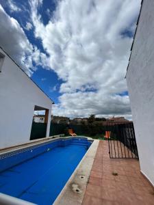 uma piscina ao lado de uma casa em El palacete azul em Almendral