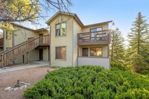 a house with a deck on the side of it at Charming Walnut Hills Condo in Flagstaff