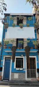 a blue building with plants on the balconies at SABRINA'S HOUSE in Giardini Naxos
