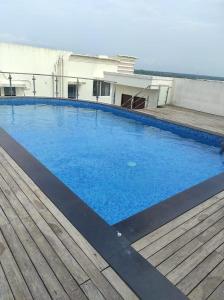 a large blue swimming pool on top of a building at Olive Celestina in Kottayam