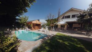 a swimming pool in the yard of a house at Căsuța de sub deal - Ciubăr și piscină in Măgura