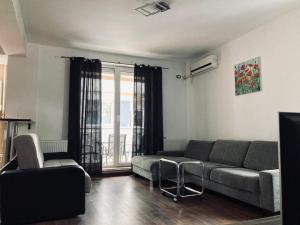 a living room with a couch and a window at Apartament EDY in Eforie Nord