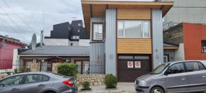 two cars parked in front of a house at Lala's Home in Ushuaia