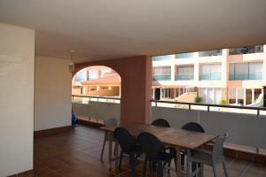 a dining room with a table and chairs on a balcony at Alta Entinas Almerimar .Modern apartment close to beach, beautiful pool. in El Ejido