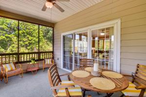 a screened in porch with a table and chairs at Kingwood Resort Condo with Golf Course Views! in Clayton