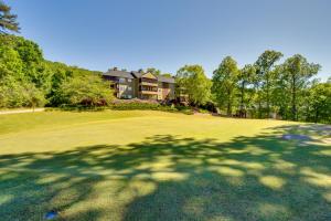 a large shadow of a tree on a golf course at Kingwood Resort Condo with Golf Course Views! in Clayton