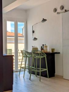 a kitchen with a table and two green chairs at Casa Moret in Sanremo +21 photos