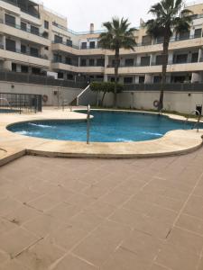 a swimming pool in front of a building at Garrucha in Garrucha