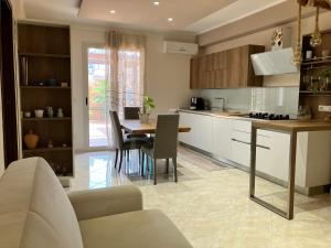 uma cozinha e sala de jantar com mesa e cadeiras em La casa dell'Asparago em Messina