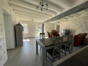 a kitchen and dining room with a table and chairs at Les mimosas in Graçay