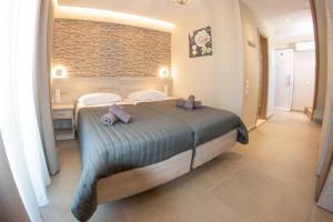 Postel nebo postele na pokoji v ubytování Jasmine Hotel & Apartments