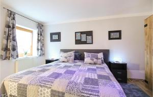 a bedroom with a purple bed with two night stands at Stunning Apartment In Deggingen With Wifi in Deggingen