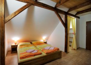 a bedroom with two beds in a attic at Resort Abertham - penzion Ellen in Abertamy