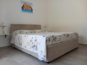 a bedroom with a bed with a blanket on it at Da Raff house in Lacco Ameno