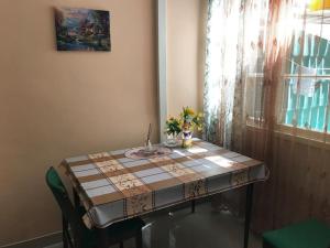 a table in a room with a table cloth on it at Lada Guest House in Tbilisi City