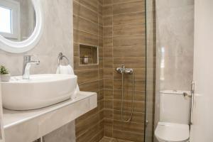 a bathroom with a sink and a toilet and a shower at Adriana's Summer House in Kassiopi +55 photos