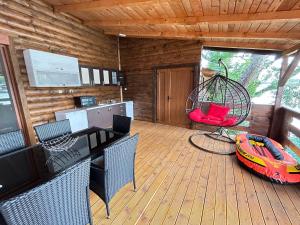 a cabin with a deck with a boat in a swing at Speakeasy Lux 3 - 4 in Ulcinj