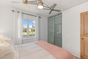 a bedroom with a bed and a ceiling fan at Marsh Front Birders Paradise Close to Beaches and Downtown in Saint Augustine