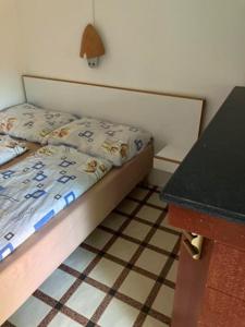 a small bedroom with a bed and a table at Faház Motel in Abádszalók