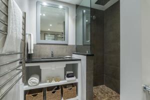 a bathroom with a sink and a shower at The Inn at Cape Cod in Yarmouth Port