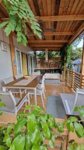a patio with a table and chairs and a wooden ceiling at Mobile Home BelDesiderio Soline in Biograd na Moru