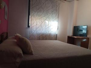 A bed or beds in a room at Hostal Cuzco