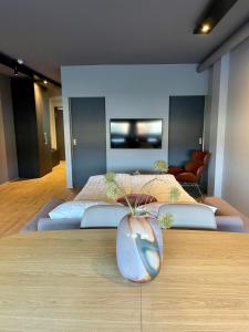 a room with two beds and a vase on a table at Modern apartment with hot tub in Akureyri in Akureyri