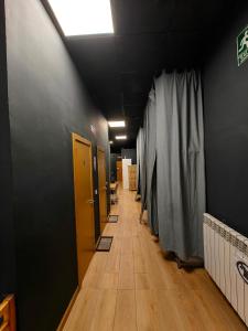 a hallway of an office with doors and a curtain at Hostal Siesta & Go in Madrid