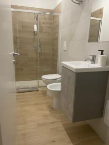 a bathroom with a toilet and a sink and a shower at GM IMMOBILIARE in Reggio di Calabria