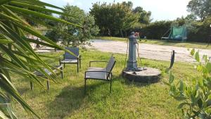 a group of chairs sitting in the grass at Casale Pamicla in Larino