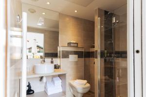 a bathroom with a toilet and a sink and a shower at Boutique H&ocirc;tel Txoko in Saint-Jean-de-Luz