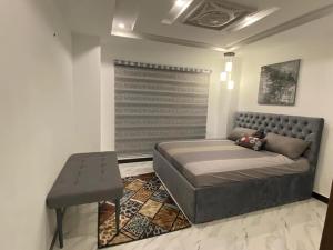 a bedroom with a bed and a table in it at The Family Den in Rawalpindi
